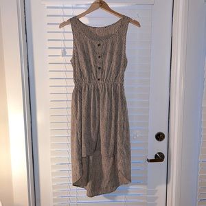 Tan and black dress with high-low hem.